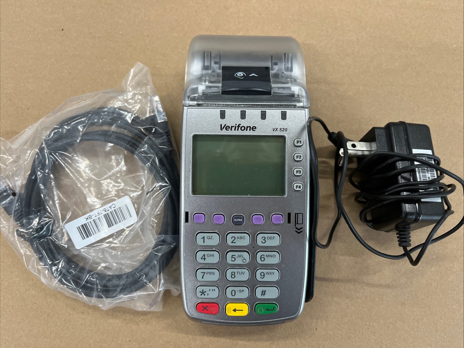 Verifone VX520 with either net cable and power cord.